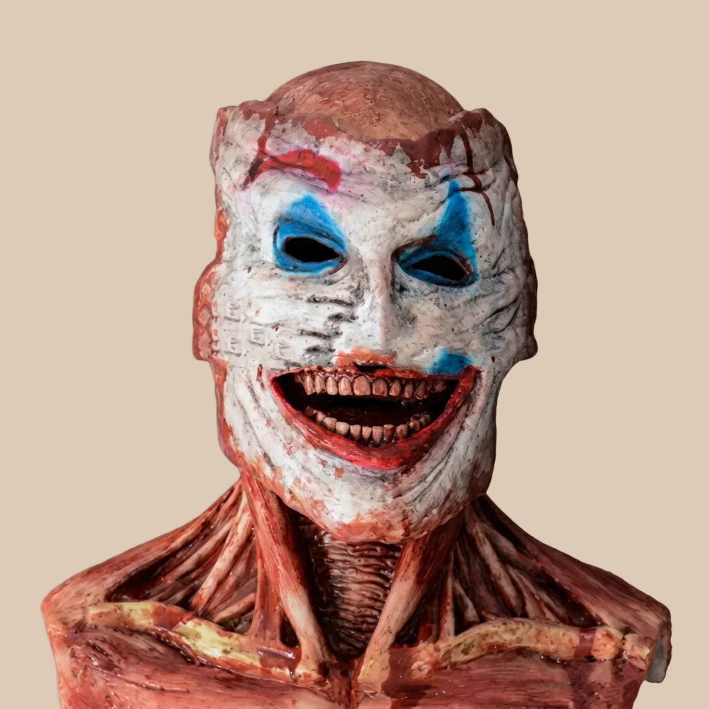 Horror clown mask with a wide grin and painted facial details, product view