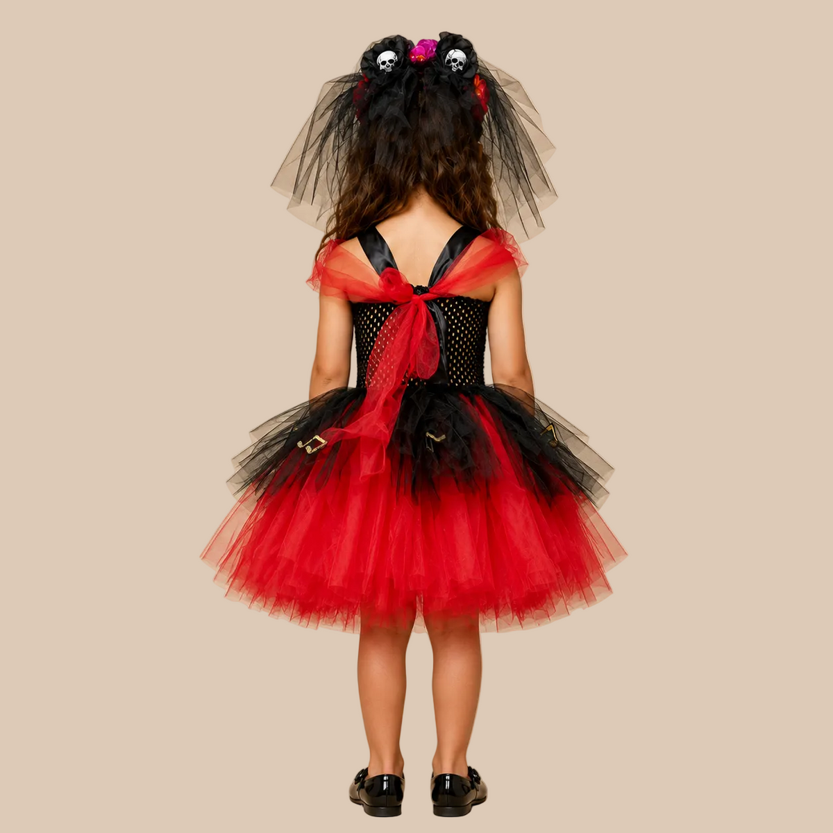 Girl’s red and black tulle dress with a skull motif, back view