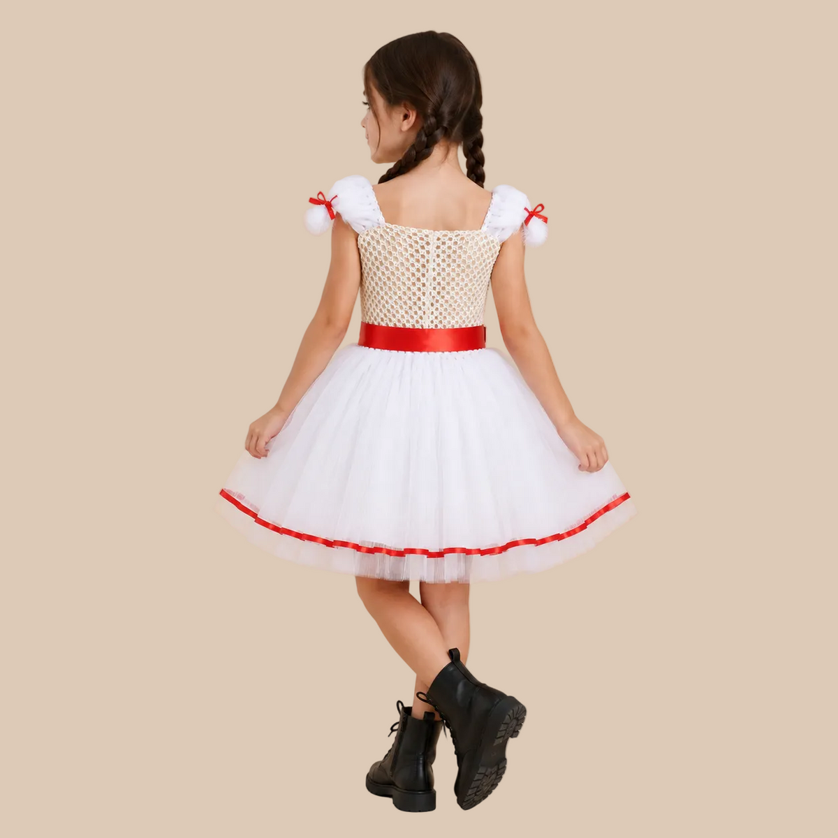 Girl’s white doll-style dress with red trim and sash, back view