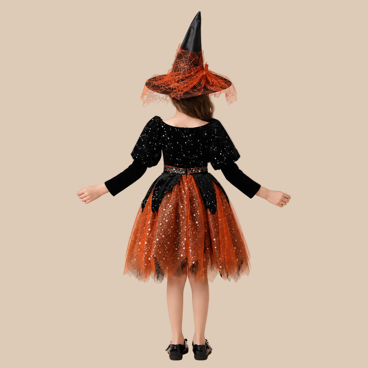 Girl’s orange and black witch dress with glittery tulle skirt, back view
