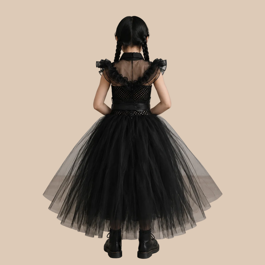 Girl’s black mesh dress with ruffled shoulders and full skirt, back view