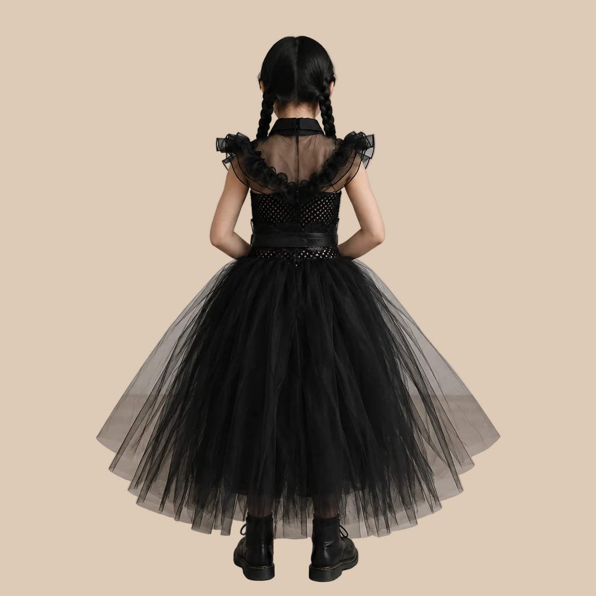 Girl’s black mesh dress with ruffled shoulders and full skirt, back view