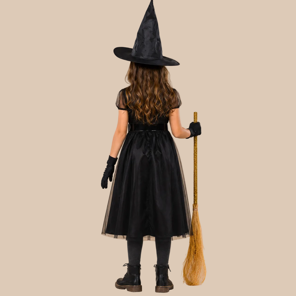 Girl’s black witch dress with sheer shoulders, back view