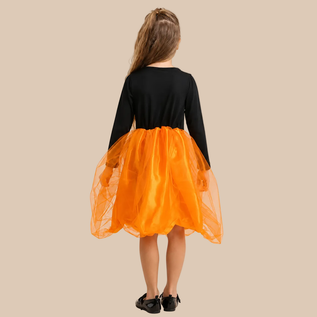 Girl’s orange pumpkin dress with black top and front lacing, back view