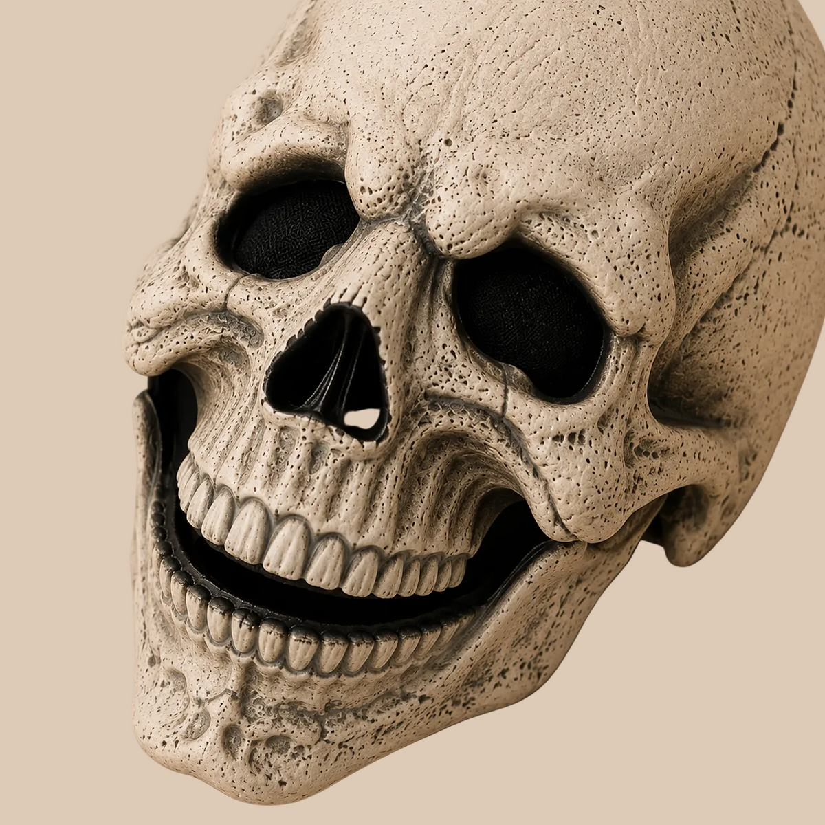 Light bone-coloured skull mask with dark eye sockets, sculpted detail close-up